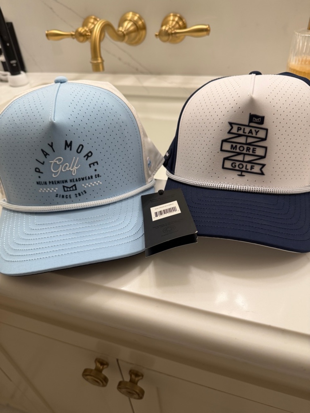 2 Melin hydro  golf caps (2) baby blue and white and navy blue and white